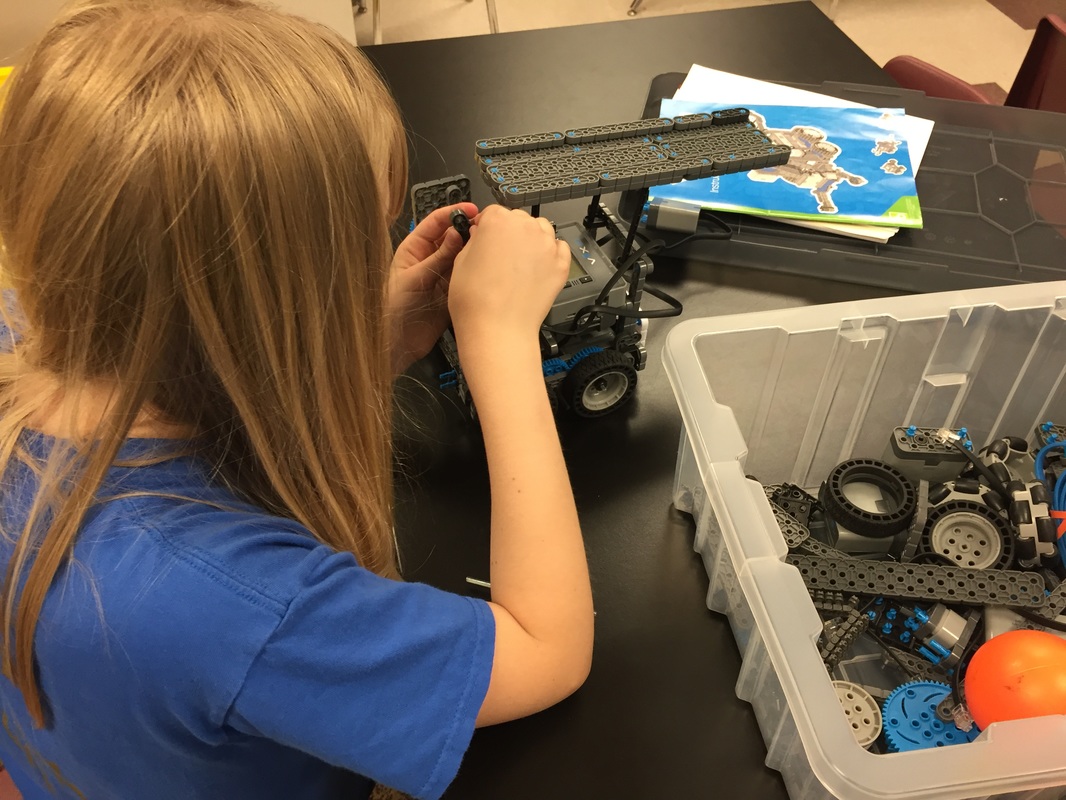 Elementary student building a VEX IQ robot, Sharks Robotics